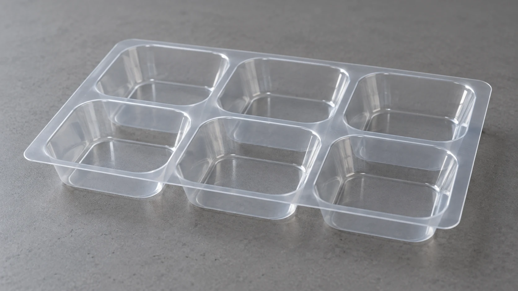 Illustrative thin clear packaging tray with six shallow cavities